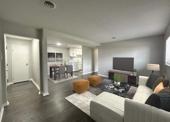 A modern living room with a grey couch, a fireplace, and a television.