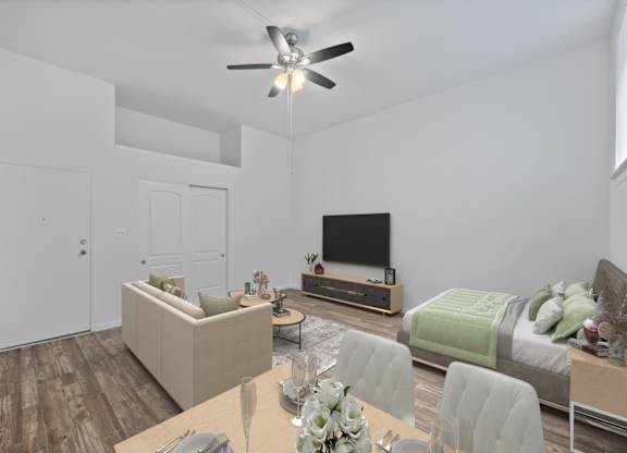 A modern living room with a television, couch, and dining table.