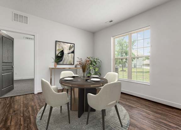 A dining room with a round table and chairs. at River View at Bexley Apartments, River View at Bexley 43209
