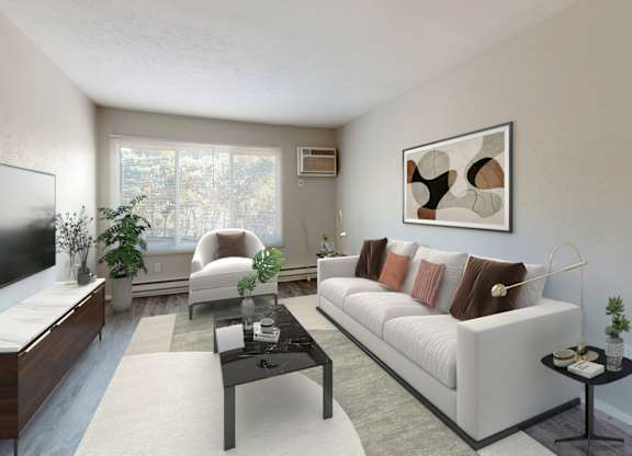 A living room with a white couch, a television, and a coffee table.