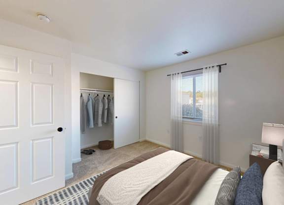 A bedroom with a large bed and a painting on the wall.
