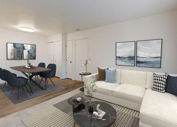 A living room with a white couch, a coffee table, and a dining table with chairs.