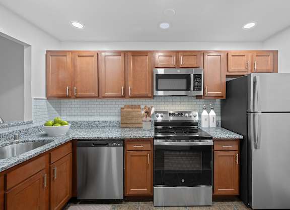A kitchen with wooden cabinets and stainless steel appliances.