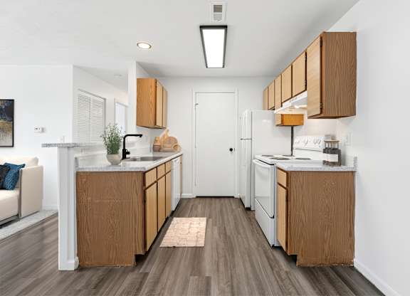 A kitchen with wooden cabinets and a white refrigerator.