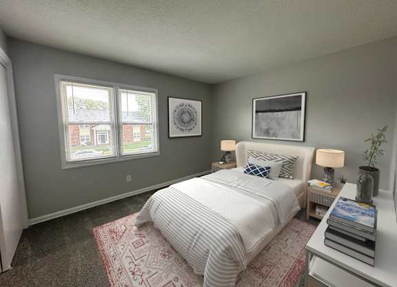 A bedroom with a bed, nightstand, and two framed pictures on the wall.