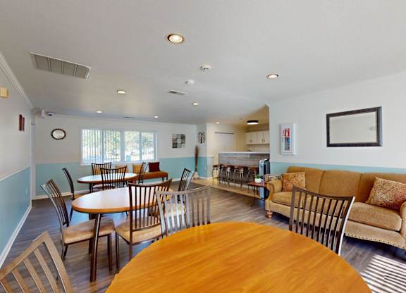 A living room with a couch, chairs, and a dining table.