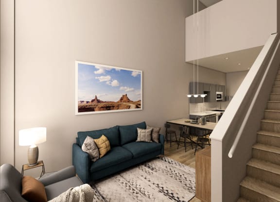 a living room with a blue couch and a staircase at Adelphi Quarter, Columbus, Ohio