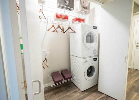 A small laundry room with a washer and dryer stacked on top of each other.at Sky Central, Cincinnati, 45202