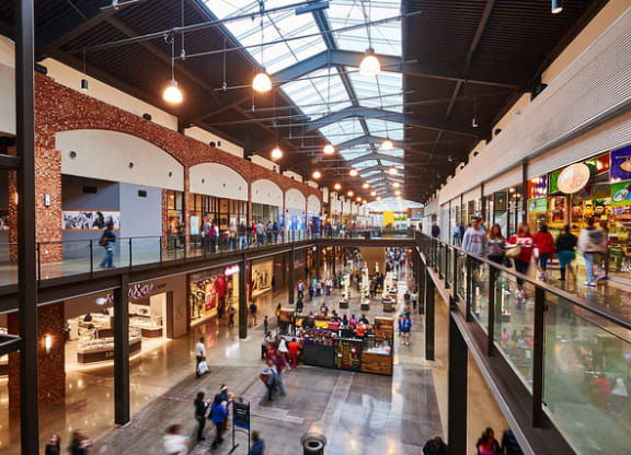 a large shopping mall with people walking through it