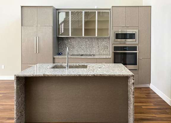 A kitchen with a granite countertop and a sink.at Sky Central, Cincinnati, 45202
