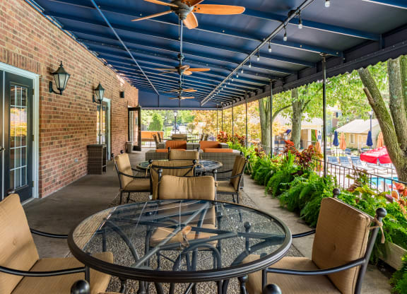 Patio with tables and chairs and a blue ceiling at Indian Creek Apartments, Cincinnati, OH, 45236