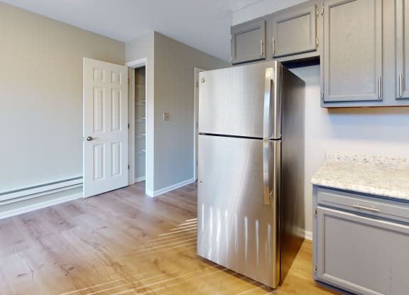 an empty kitchen with a stainless steel refrigerator and extra storage at Ridgeview, Indiana