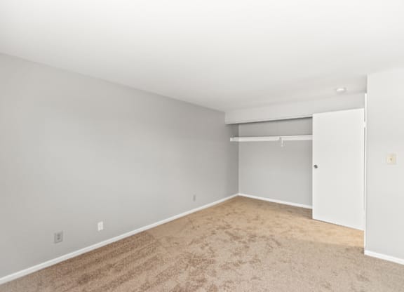 A room with a carpeted floor and white walls.