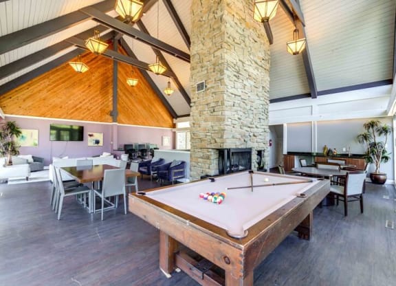 Pool table in a large room with a stone fireplace at Summit at Keystone, Indianapolis, IN 46220