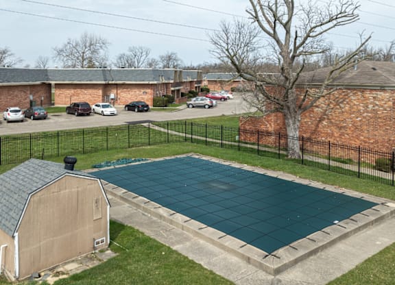 A small swimming pool surrounded by a black fence.