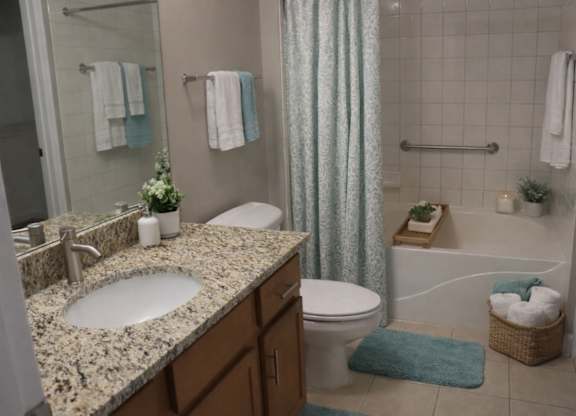 A bathroom with a sink, toilet, and bathtub.