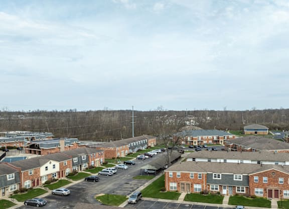 A view of a residential area with houses and cars.