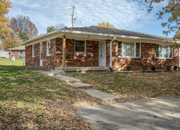 a small brick house with a sidewalk in front of it  at Stonebrook of Franklin, Franklin