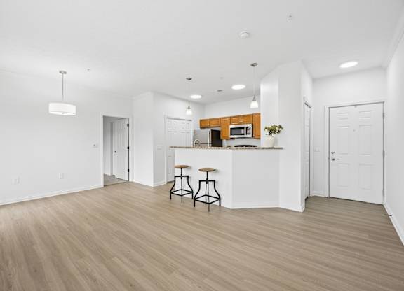 A kitchen with a bar stool and a countertop.