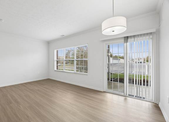 A room with a sliding glass door leading to a balcony.