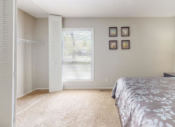 Bedroom with a bed and a closet at Summit at Keystone, Indianapolis, IN