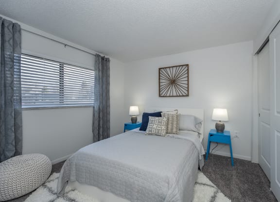 Bedroom with cozy bed and window at Mallard Landing Apartments , Marion, OH