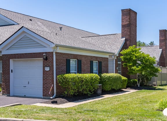 a brick house with a white garage door at Bishops Gate, Ohio, 45249