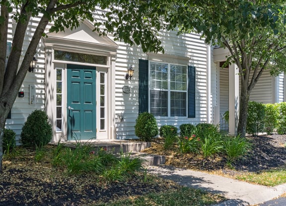 a white house with a green door and a front porch at Bishops Gate, Cincinnati