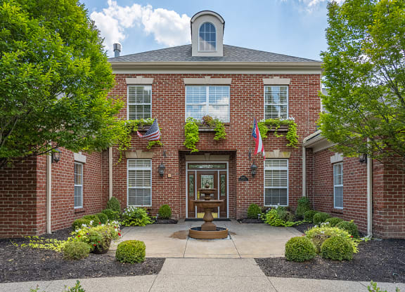 a front view of a brick building with a fountain at Bishops Gate, Cincinnati, OH, 45249