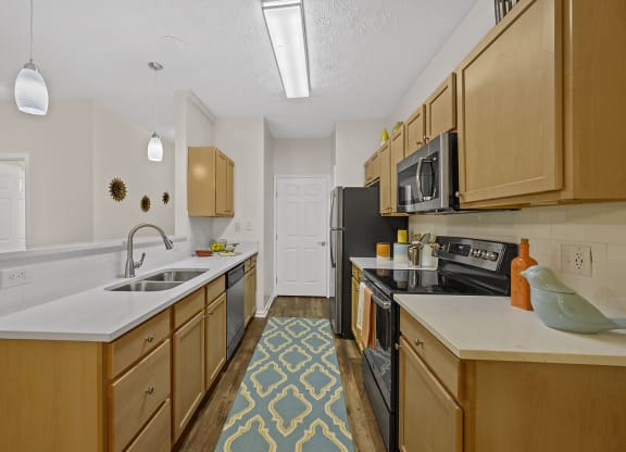 Kitchen with wooden cabinets and sink at Bishops Gate, Cincinnati, 45249
