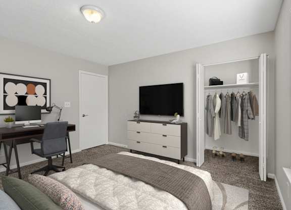 A bedroom with a bed, desk, and closet.