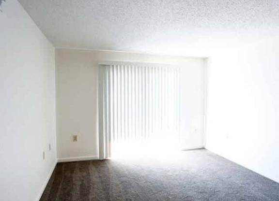 A room with a sliding door and wooden flooring.