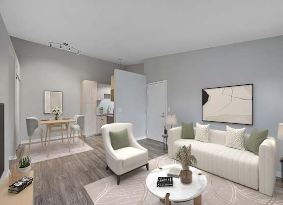 A living room with a white sofa, a white armchair, a wooden coffee table, and a painting on the wall. at The Reserve at Grand Valley Apartments, Milford, 45150