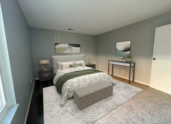 a bedroom with gray walls and a white and green bed