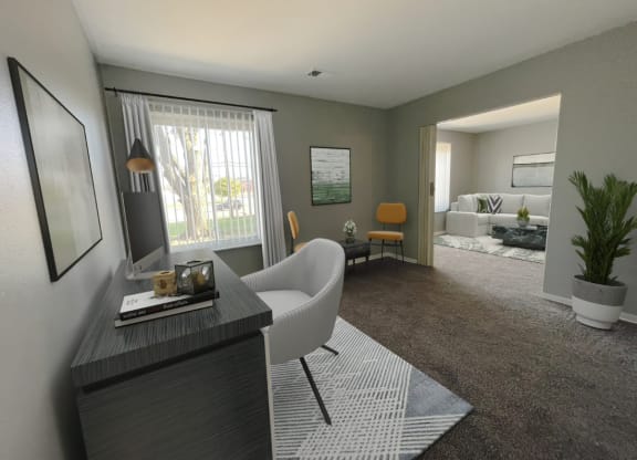 a living room with a couch and a chair in front of a window