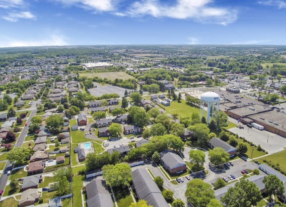 an aerial view of a city with a water tower in the middle of it