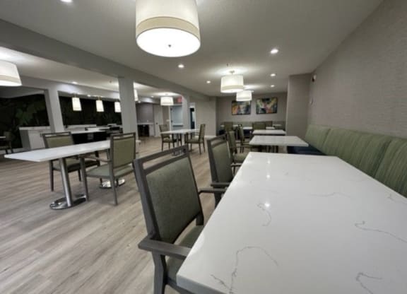 a large dining room with tables and chairs