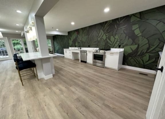 a large room with a kitchen and a dining area