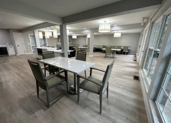 a dining area with a table and chairs