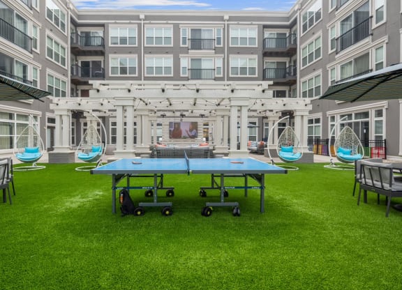a ping pong table in front of an apartment building