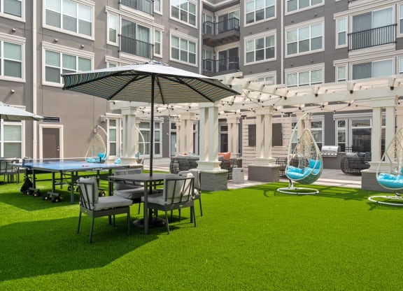 a courtyard with tables and chairs and umbrellas at the bradley braddock road
