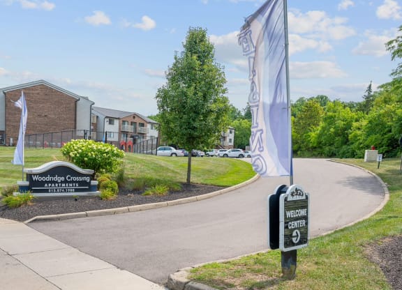 a building with a sign that reads woodland commons with a mailbox in the foreground at The Woodridge Collection, Fairfield, OH