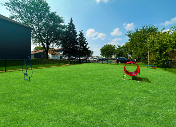 a large grassy area with a playground