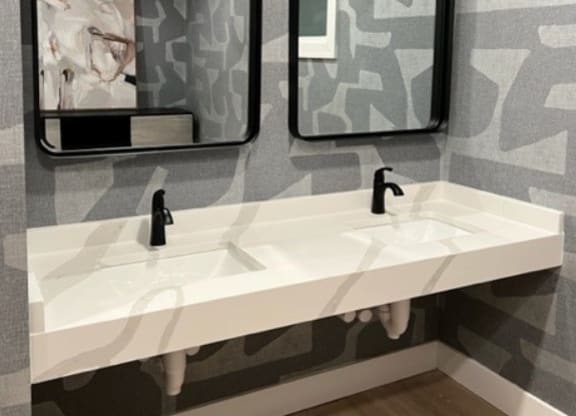 Bathroom with a gray and white wallpaper and two mirrors at Waterstone Landing, Perrysburg