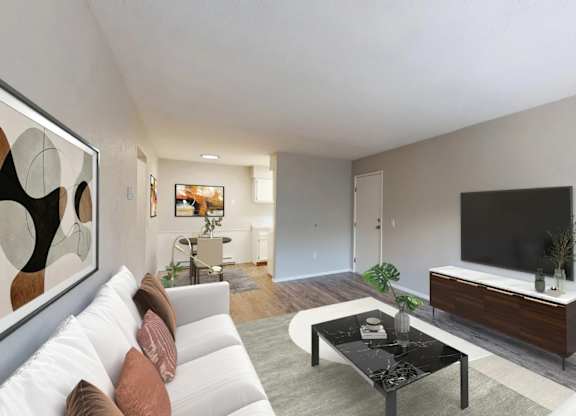 A modern living room with a white sofa, a black coffee table, and a large painting on the wall.