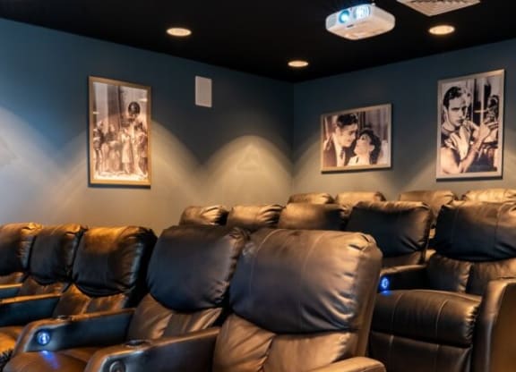 Home theater room with leather chairs and blue walls at Waterstone Landing, Ohio