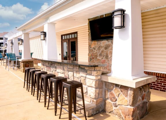 Row of bar stools in front of a stone wall with a bar counter at Waterstone Landing, Perrysburg