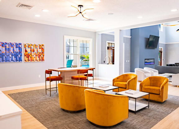 Living room with yellow chairs and a table with a laptop at Waterstone Landing, Perrysburg, OH, 43551