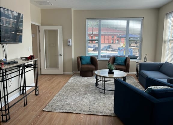 an apartment living room with couches and a table