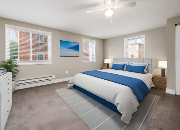 a bedroom with a bed and a ceiling fan